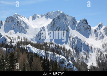 great panormaric view of moutains with white snow in winter from Lussari Mount in Northern Italy Stock Photo