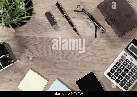 top view.business background.calculator,mobile phone and other items on wooden table Stock Photo