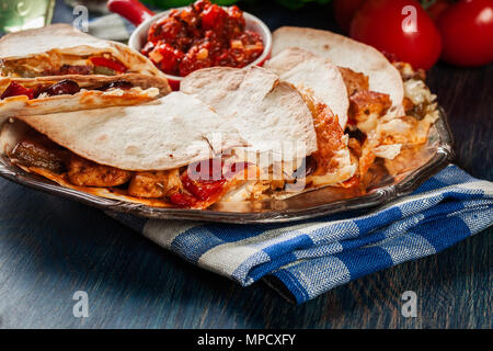 Mexican Quesadilla with chicken, sausage chorizo and red pepper served with salsa Stock Photo