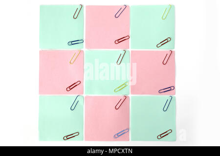 multiple blank sheets for notes with paper clips isolated on white background Stock Photo