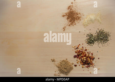 Selection of spices on wooden board Stock Photo