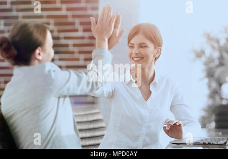 members of the business team giving each other a high five. Stock Photo