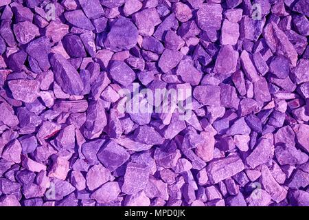 Ultra violet colored Pebble textured surface, stone backdrop and boulder background. Stock Photo