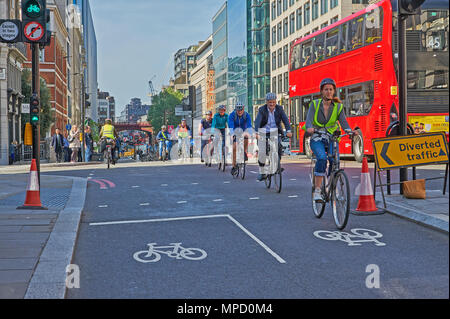 Commuters cycling to work on an urban street Stock Photo