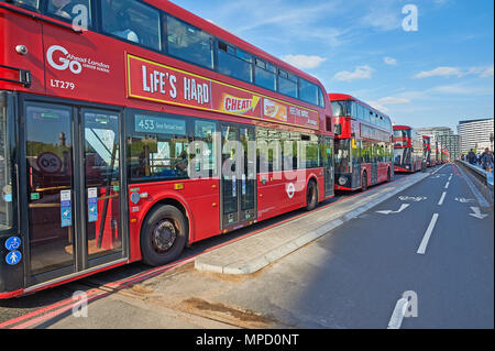 London Westminster Bridge and a line of red double decker buses Stock Photo