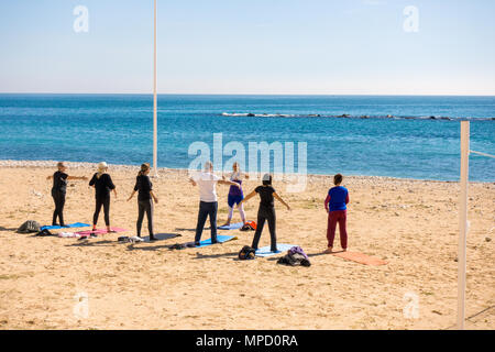 Active people doing exercises on the beach in Altea, Spain. Stock Photo