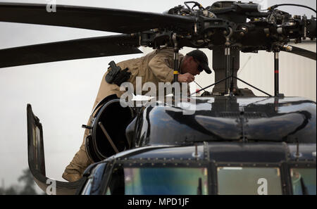 An air interdiction agent inspects the UH-60 Black Hawk helicopter ...