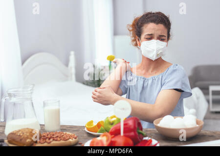 Young woman experiencing an egg allergy Stock Photo