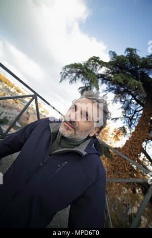 Portrait of Mature caucasian man smiling in the park Stock Photo