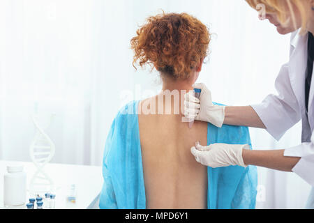 Young woman having her skin examined by a doctor Stock Photo