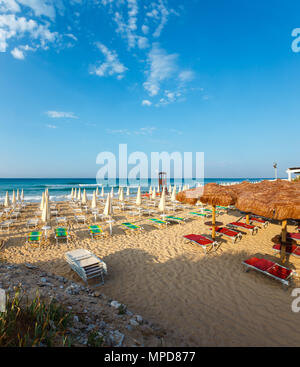 Morning paradise white sandy beach The Maldives of Salento with sunshades and sunbeds (Pescoluse, Salento, Puglia, south Italy). Two shots stitch imag Stock Photo