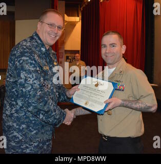 170208-N-SP496-024 SILVERDALE, Wash. (Feb. 8, 2017) – Capt. Alan Schrader (left), Naval Base Kitsap (NBK) commanding officer, presents Culinary Specialist 1st Class Nicholas Gagner with the Navy and Marine Corps Achievement Medal during an all-hands call held at the NBK-Bangor Theater. More than 30 awards and decorations were bestowed to NBK personnel during the event. (U.S. Navy photo by Petty Officer 3rd Class Jane Wood/Released) Stock Photo