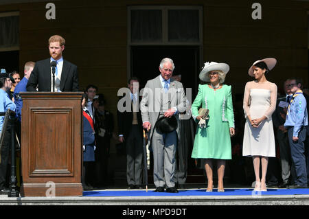 The Prince of Wales, the Duchess of Cornwall and the Duchess of Sussex, listen as the Duke of Sussex speaks during a garden party at Buckingham Palace in London, which the newly weds are attending as their first royal engagement as a married couple. Stock Photo