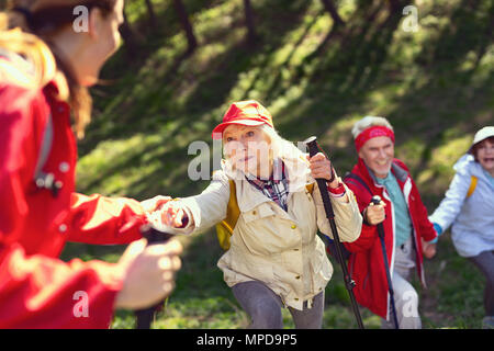 Cheerful team hiking in the forest Stock Photo