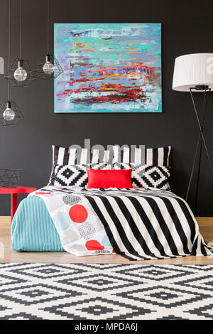 New bedroom with black wall, large bed and pattern details Stock Photo