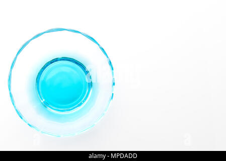 Crystallizing dish (crystallising) of copper sulfate solution (copper chloride) blue liquid isolated on white reflective background with shallow depth Stock Photo
