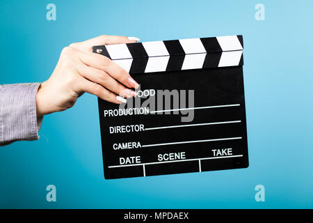 Female hands holding a clapperboard Stock Photo