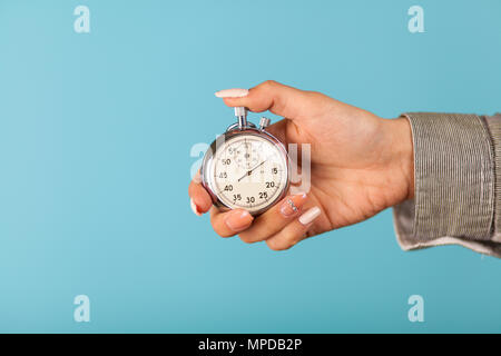 Female hand holding a stopwatch Stock Photo