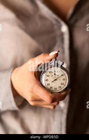 Female hand holding a stopwatch Stock Photo