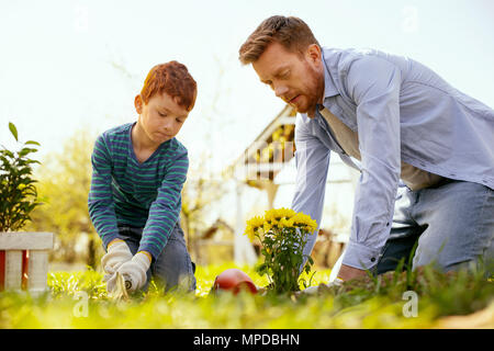 Hard working nice man sitting on the ground Stock Photo