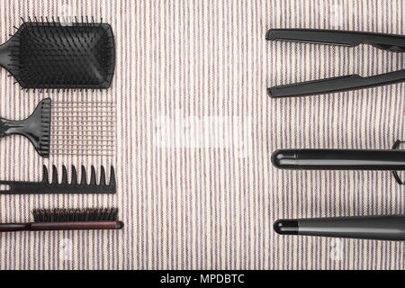 hair straightening tools lying opposite to combs Stock Photo