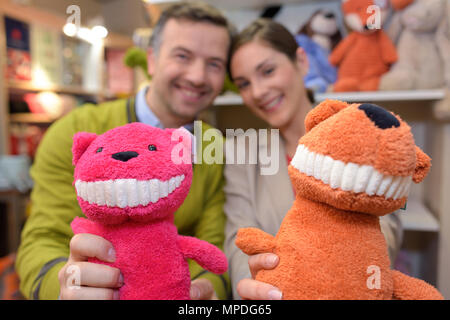 parents-to-be shopping choosing plush for their kid Stock Photo