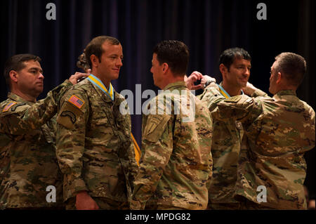 U.S. Army Rangers Capt.  Michael Rose and Master Sgt. Josh Horsager of the 75th Ranger Regiment receive awards for winning first place in the Best Ranger Competition 2017 at Fort Benning, Ga., April 10, 2017. The 34th annual David E. Grange Jr. Best Ranger Competition 2017 is a three-day event consisting of challenges to test competitor's physical, mental, and technical capabilities. Stock Photo