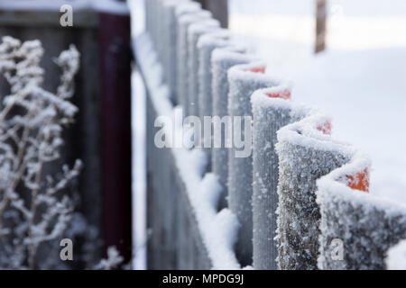Hoarfrost on corrugated fence in perspective Stock Photo