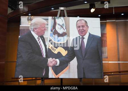 A photo depicting President Trump and Russian Foreign Minister Sergei Lavrov shaking hands while meeting in the oval office is displayed on the stage prior to a House Democratic press conference explaining democrats' efforts to establish an independent commission on Trump's ties to Russia on May 17th, 2017 at the U.S. Capitol. Stock Photo