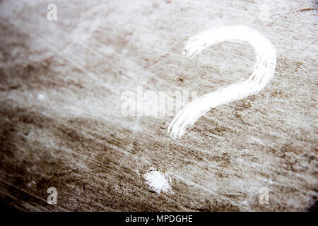 question mark is drawn on scratched dirty background Stock Photo