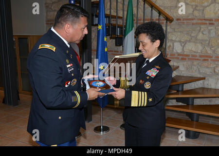 U.S. Army Col. Darius S. Gallegos, CoESPU deputy director (left), presents Carabinieri CoESPU crest to Admiral Michelle Howard, NATO JFC-Naples Commander, during the visit at the Center of Excellence for Stability Police Units (CoESPU) Vicenza, April 10, 2017.