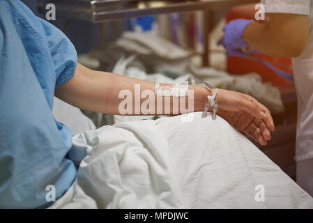 Nurse set catheter in patient hand close up view Stock Photo