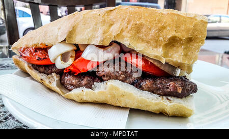 Turkish Kofte Ekmek / Meatball Sandwich with tomatoes, onion and green pepper. Traditional Fast Food. Stock Photo