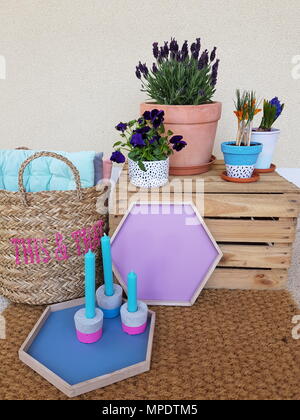 Table with retro objects on it, flowers vase, flower, wooden box, outdoor Stock Photo