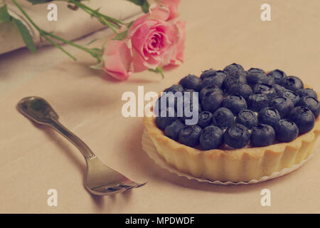 Romantic. A Tart with blueberry near roses Stock Photo