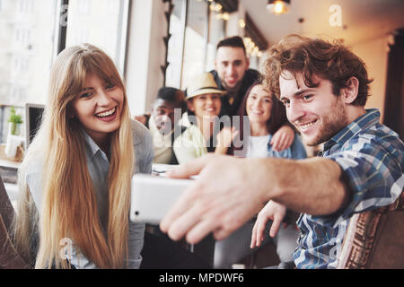 Group portrait of Cheerful old friends communicate with each other, friend posing on cafe, Urban style people having fun, Concepts about youth togetherness lifestyle. Wifi connected Stock Photo