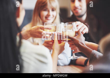 Hands of people with glasses of whiskey or wine, celebrating and toasting in honor of the wedding or other celebration Stock Photo