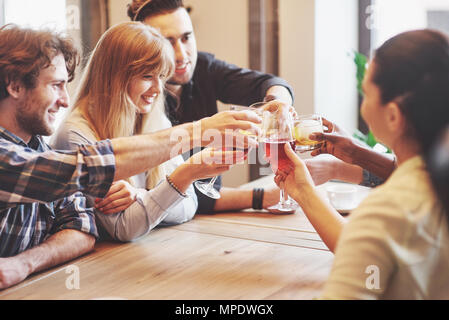 Hands of people with glasses of whiskey or wine, celebrating and toasting in honor of the wedding or other celebration Stock Photo