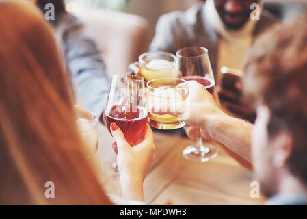 Hands of people with glasses of whiskey or wine, celebrating and toasting in honor of the wedding or other celebration Stock Photo