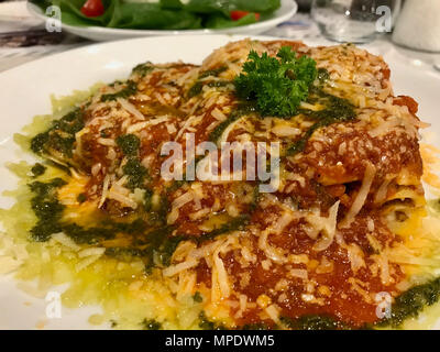 Traditional Minced Meat Lasagna with Bolognese and Pesto Sauce served at Restaurant. Organic food. Stock Photo