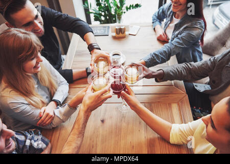 View from the top. Hands of people with glasses of whiskey or wine, celebrating and toasting in honor of the wedding or other celebration Stock Photo