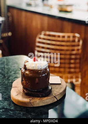 Melted Belgium Chocolate Dessert with Whipped Cream and Strawberry in Jar served at Restaurant. Organic Dessert. Stock Photo