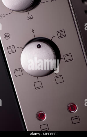 thermostat and handles on a modern microwave, close-up. kitchen equipment Stock Photo