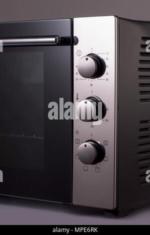 thermostat and handles on a modern microwave. kitchen equipment Stock Photo