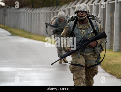 Torii Station, Okinawa (Feb 12, 2017) – Spc. Jamail Crawford takes part in a 12-mile ruck march as the final evolution in the US Army Japans best warrior competition. The top competitors of this competition will continue on to compete in a pacific-wide competition in Hawaii. (U.S. Navy photo by Mass Communication Specialist Taylor Mohr) Stock Photo