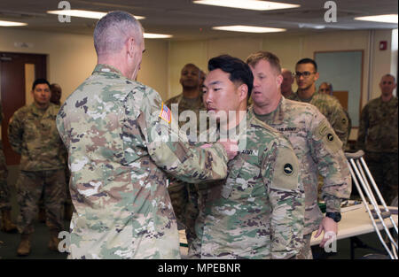 Torii Station, Okinawa (Feb 12, 2017) – Maj. Gen. James Pasquarette awards Sgt. Andrew Lee an Army commendation medal for being the top NCO finisher in US Army Japans best warrior competition in Okinawa. The top competitors of this competition will continue on to compete in a pacific-wide competition in Hawaii. (U.S. Navy photo by Mass Communication Specialist Taylor Mohr) Stock Photo