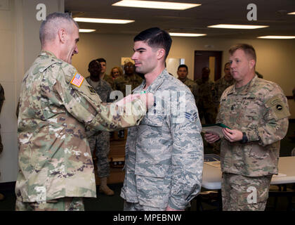 Torii Station, Okinawa (Feb 12, 2017) – Maj. Gen. James Pasquarette awards Senior Airman Ryan Lavoie  an Army commendation medal for being a top finisher in US Army Japans best warrior competition in Okinawa. The top competitors of this competition will continue on to compete in a pacific-wide competition in Hawaii. (U.S. Navy photo by Mass Communication Specialist Taylor Mohr) Stock Photo