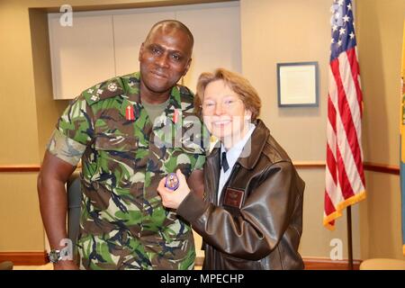 Brig. Gen. Rodney Smart, Chief of the Trinidad and Tobago Defence Staff, presents Brig. Gen. Carol Timmons with his coin, signifying his commitment to fostering and growing the state partnership program. (U.S. Army National Guard photo by Lt. Col. Len Gratteri) Stock Photo