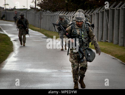 Torii Station, Okinawa (Feb 12, 2017) – Sgt. Keila Hernandez takes part in a 12-mile ruck march as the final evolution in the US Army Japans best warrior competition. The top competitors of this competition will continue on to compete in a pacific-wide competition in Hawaii. (U.S. Navy photo by Mass Communication Specialist Taylor Mohr) Stock Photo