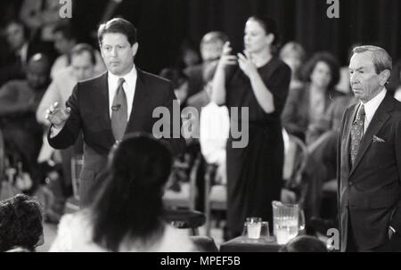 A man delivers a speech to a crowd during a USAID event, with a woman providing sign language interpretation to ensure accessibility. The gathering includes members of the public who listen to the speaker’s remarks. The scene highlights inclusive communication and educational outreach conducted by a U.S. government agency, focusing on public awareness, participation, and accessibility. Stock Photo